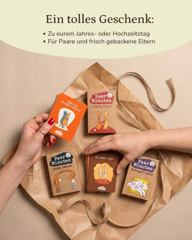 Von oben: auf Kraftpapier liegen die Schachteln PaarMinuten Fürs Herz, Gute Laune und Bettgeflüster mit einem Kartenstapel der Kategorie „Du oder ich?“; eine Hand hält eine orangefarbene Karte „Kleine Schmeichelei“ ins Bild. Eingeblendet: „Ein tolles Geschenk: Zu eurem Jahres- oder Hochzeitstag · Für Paare und frisch gebackene Eltern“